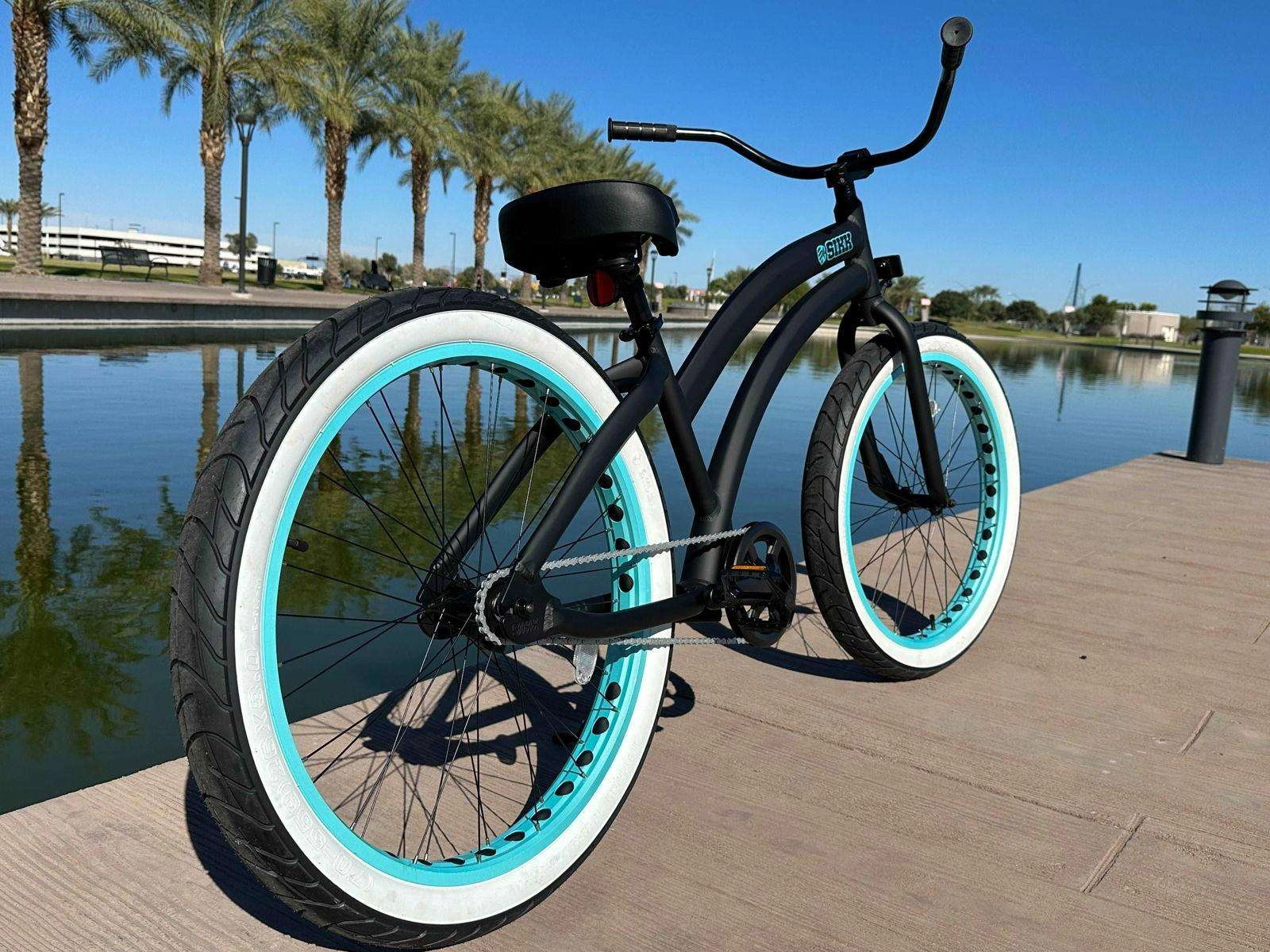 Bicicleta SIKK Wide Ride Flat Black Teal Wheels Elegancia Urbana Rodada Única Mujer